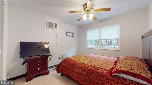 bedroom with ceiling fan, a wall mounted AC, baseboards, and light tile patterned floors