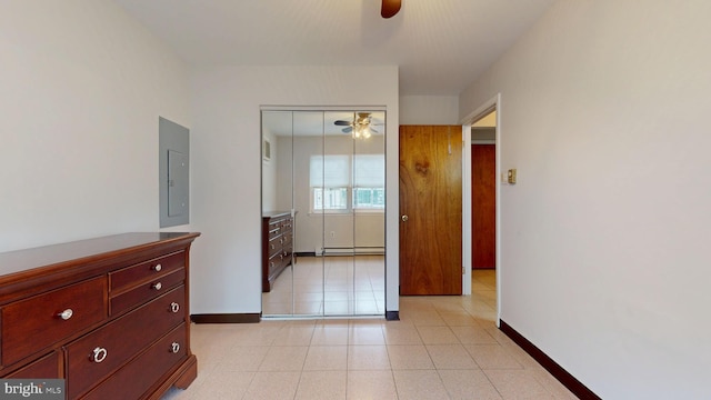 unfurnished bedroom with baseboards, baseboard heating, a ceiling fan, and electric panel