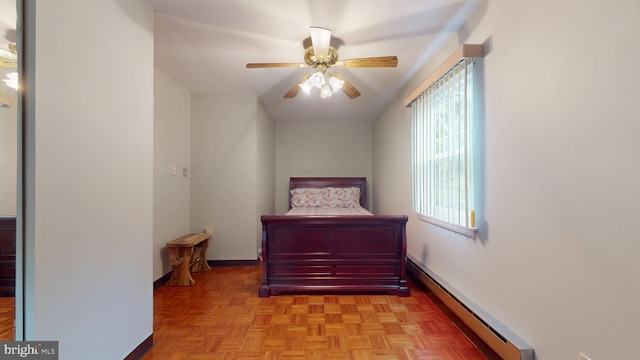 bedroom with a baseboard heating unit, baseboards, and a ceiling fan