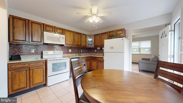 kitchen featuring a ceiling fan, a baseboard radiator, light tile patterned floors, white appliances, and tasteful backsplash