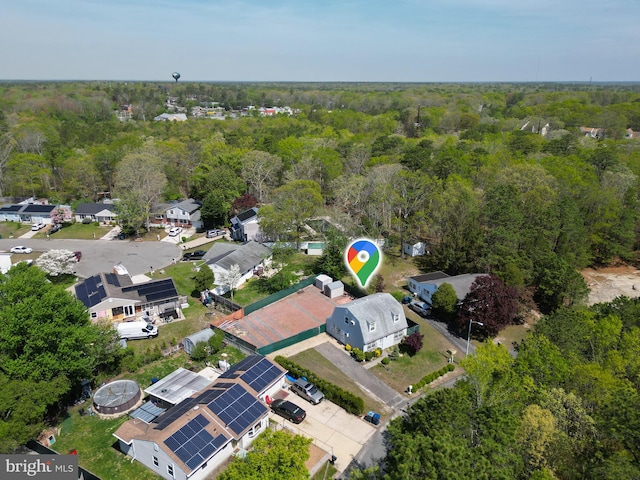 drone / aerial view with a forest view and a residential view