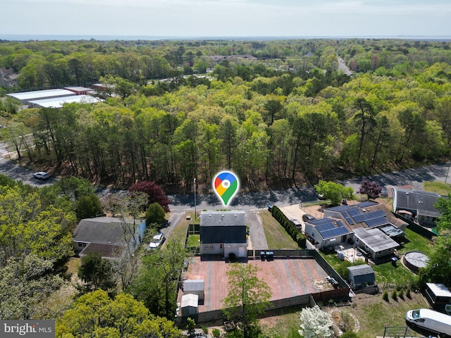 birds eye view of property with a view of trees