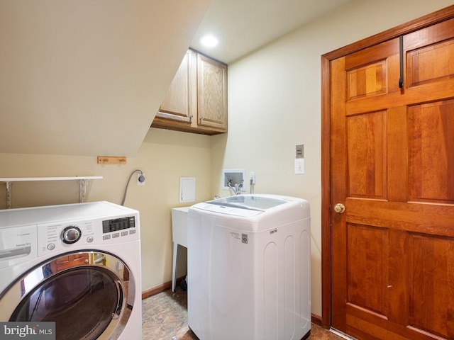 laundry area with washing machine and clothes dryer, cabinet space, and baseboards