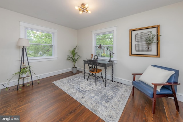 home office featuring a chandelier, baseboards, and wood finished floors