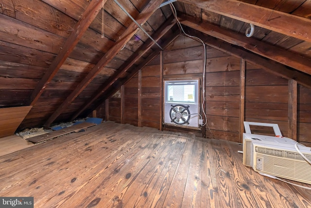 unfinished attic featuring a wall mounted AC