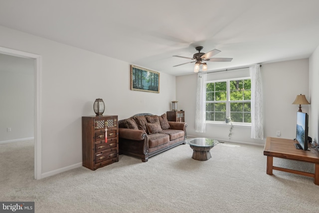 living area with a ceiling fan, carpet flooring, and baseboards