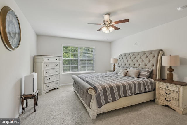 bedroom with light carpet and ceiling fan