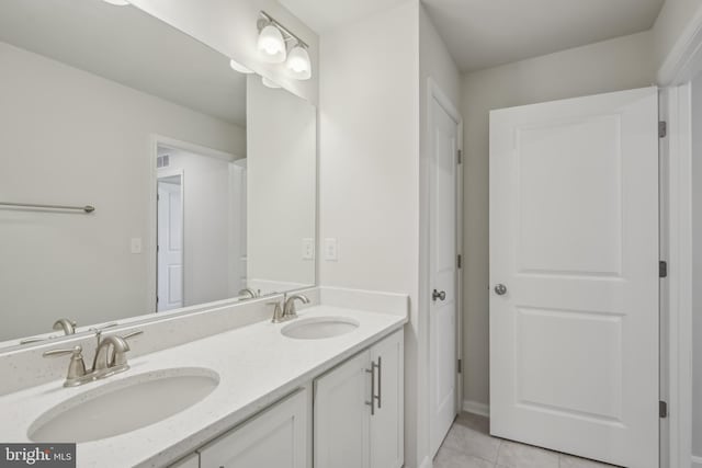 full bath with a sink, tile patterned flooring, and double vanity