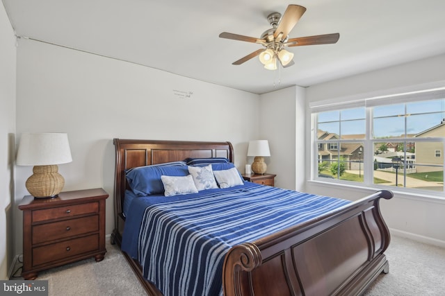 bedroom with baseboards, light carpet, and ceiling fan