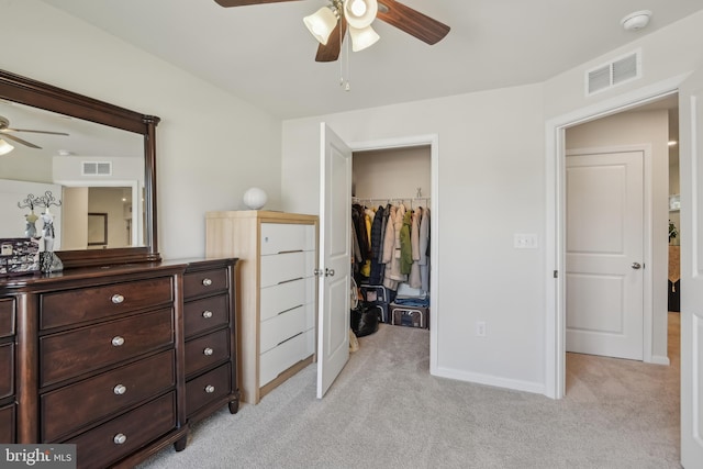 bedroom with light carpet, a spacious closet, a closet, and visible vents