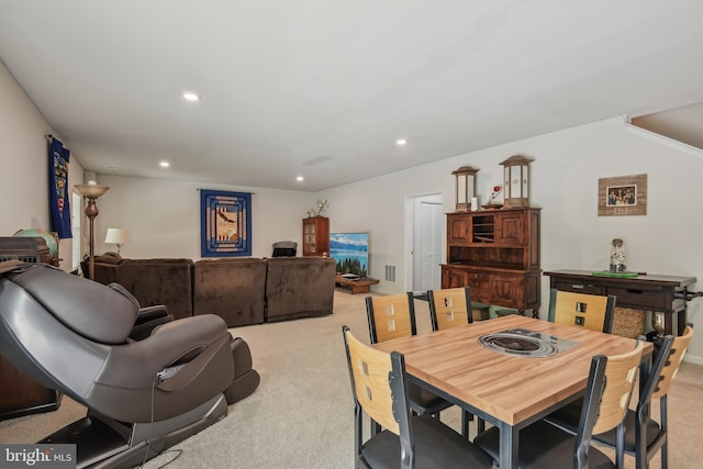 dining space featuring light carpet, visible vents, and recessed lighting