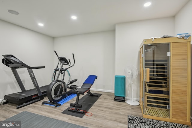 exercise room with wine cooler, recessed lighting, baseboards, and wood finished floors