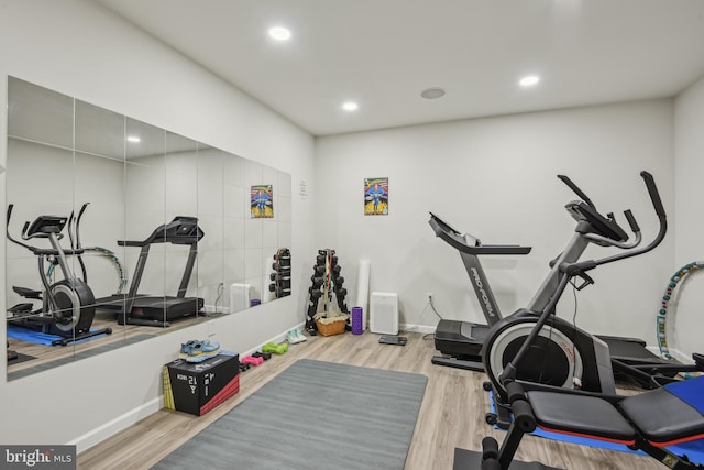 workout area with recessed lighting, baseboards, and wood finished floors