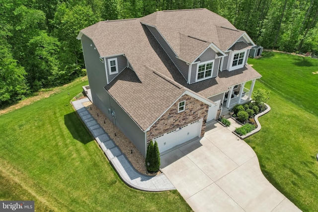 bird's eye view with a wooded view