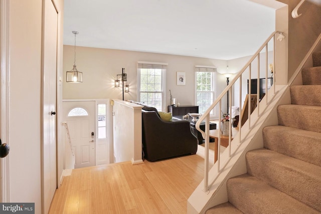 foyer entrance with light wood-type flooring and stairs