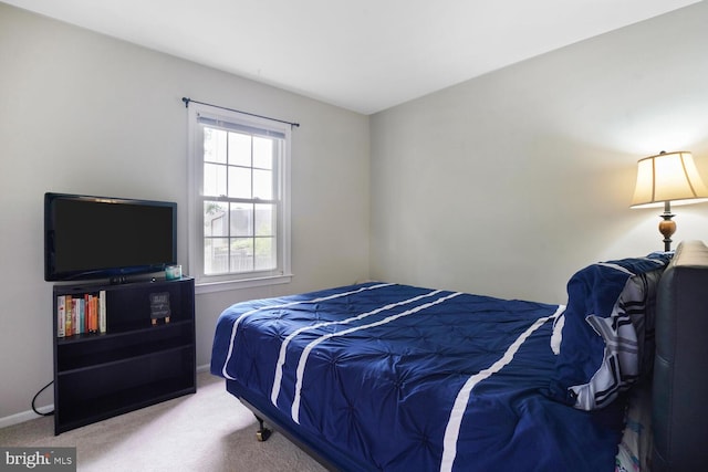 carpeted bedroom featuring baseboards