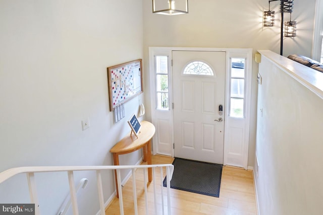 entryway with light wood-type flooring and baseboards