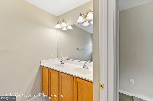 1007 Whispering Ponds Ct, Salisbury, MD 21804 - bathroom featuring double vanity and baseboards