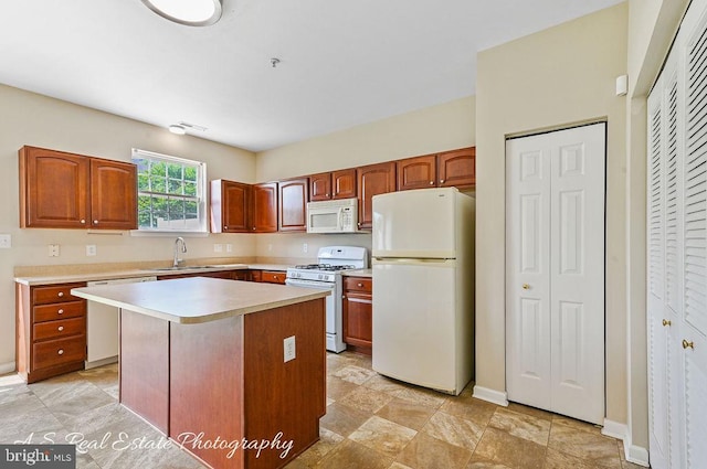 1007 Whispering Ponds Ct, Salisbury, MD 21804 - kitchen with white appliances, light countertops, a kitchen island, a sink, and baseboards