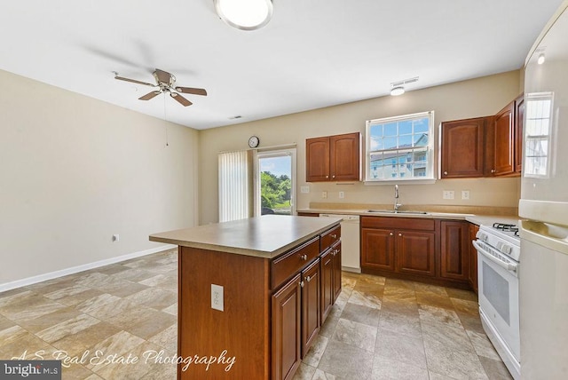 1007 Whispering Ponds Ct, Salisbury, MD 21804 - kitchen featuring white appliances, a sink, ceiling fan, a center island, and light countertops