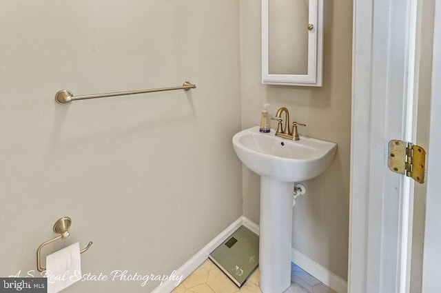 1007 Whispering Ponds Ct, Salisbury, MD 21804 - bathroom featuring baseboards, a sink, and tile patterned flooring