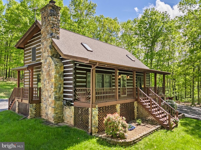 rear view of property with stairway, log siding, a porch, and a chimney