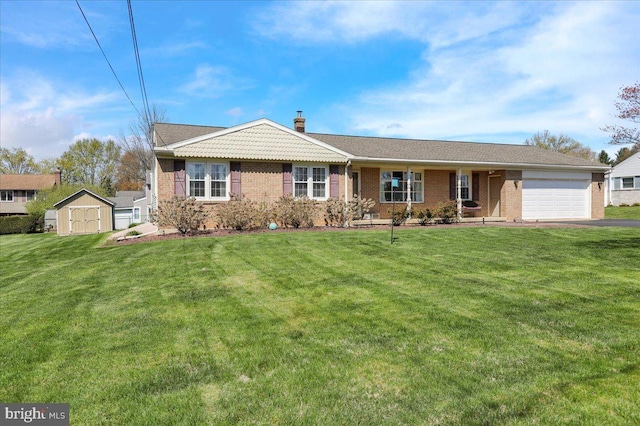 ranch-style house featuring a chimney, brick siding, an attached garage, a front yard, and aphalt driveway