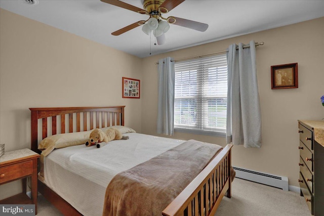 bedroom with a baseboard heating unit, baseboards, ceiling fan, and carpet