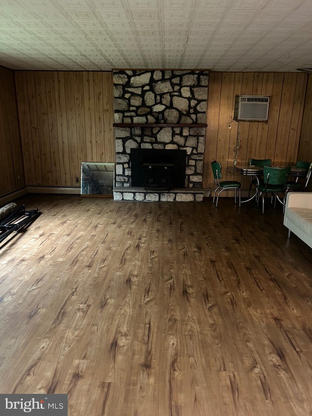 1535 Fieldwood Rd, Southampton, PA 18966 - unfurnished living room featuring a fireplace, an AC wall unit, wood finished floors, and wood walls