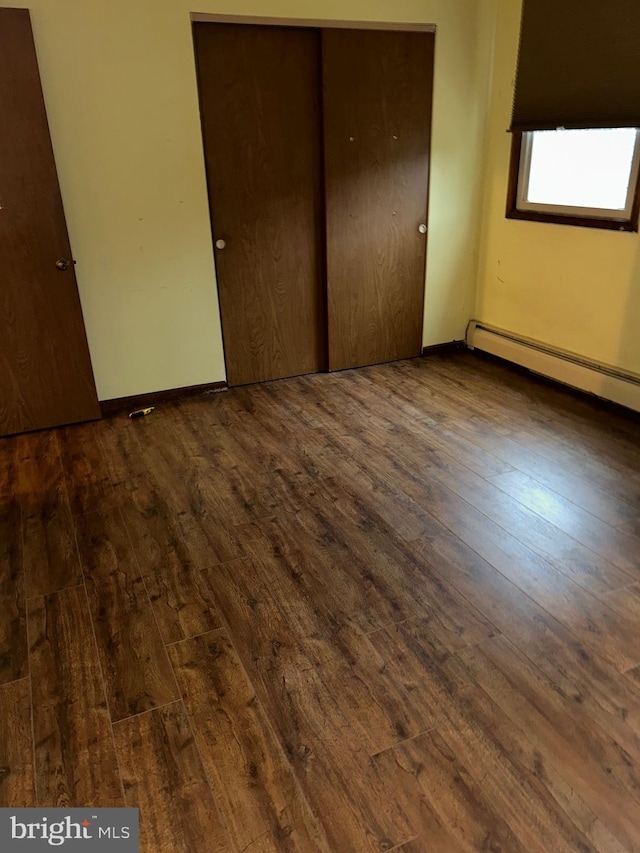 1535 Fieldwood Rd, Southampton, PA 18966 - unfurnished bedroom featuring wood-type flooring, a closet, a baseboard heating unit, and baseboards