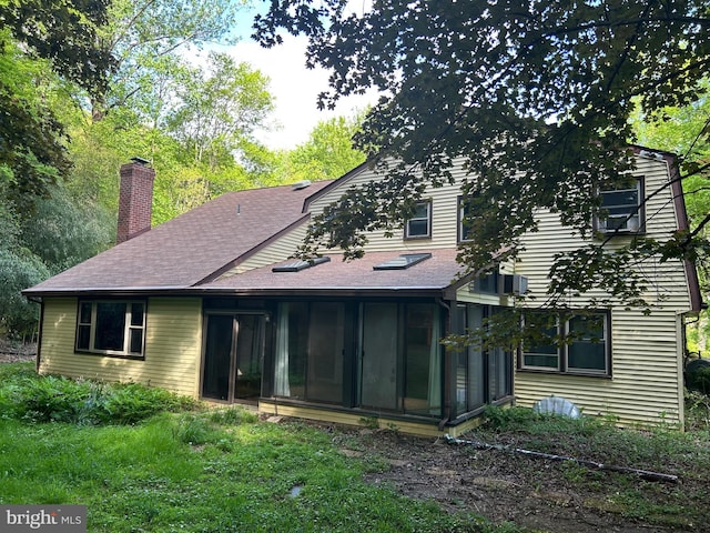 1535 Fieldwood Rd, Southampton, PA 18966 - back of property featuring a sunroom, a chimney, and a shingled roof