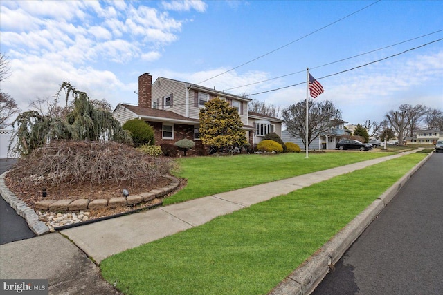 48 Creighton Cir, Old Bridge, NJ 08857 - view of home's exterior with a yard, a chimney, and brick siding
