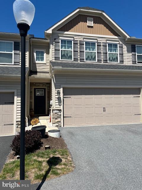 view of front of home featuring an attached garage and driveway