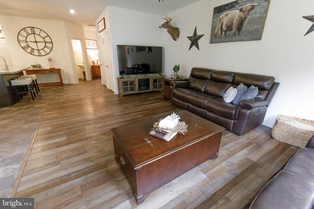 living area featuring wood finished floors and recessed lighting
