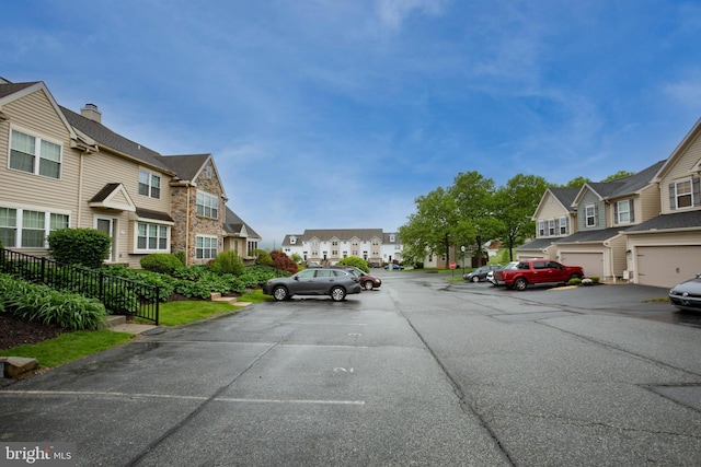 view of asphalt road with a residential view
