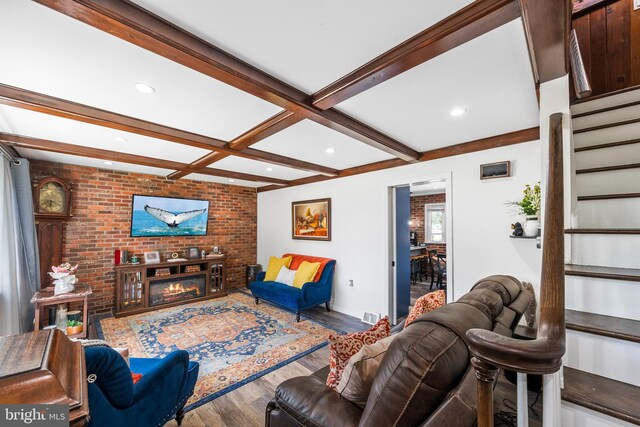 living area with wood finished floors, stairway, beamed ceiling, recessed lighting, and baseboards