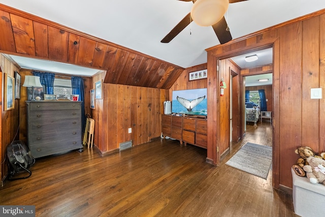 bonus room with wood walls, ceiling fan, hardwood / wood-style flooring, lofted ceiling, and plenty of natural light