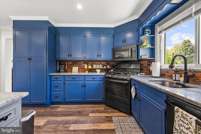kitchen with stainless steel microwave, range with gas stovetop, black dishwasher, a sink, and blue cabinets