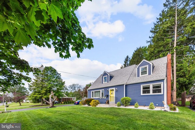 cape cod house with a front lawn and a shingled roof