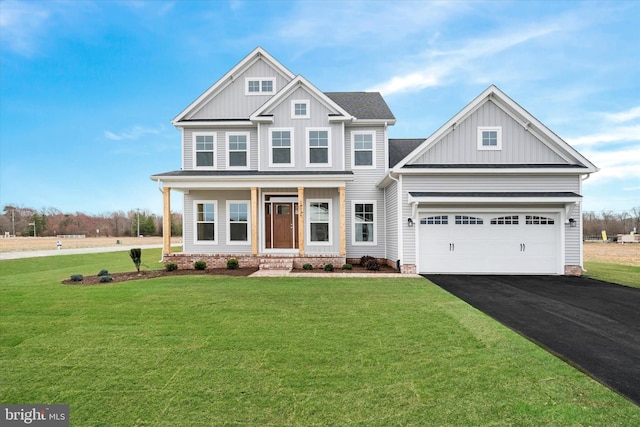 view of front of house featuring driveway, a front lawn, and board and batten siding
