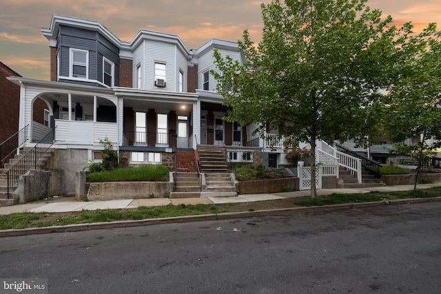 524 N Loudon Ave, Baltimore, MD 21229 - multi unit property with cooling unit, a porch, and stairs