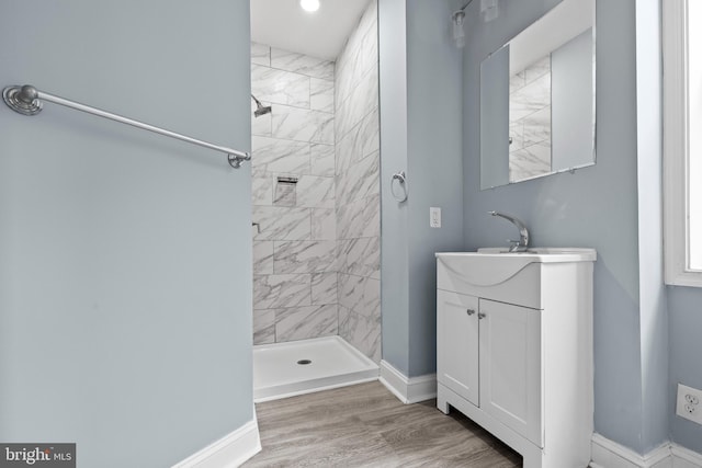 524 N Loudon Ave, Baltimore, MD 21229 - full bathroom with vanity, wood finished floors, baseboards, and a tile shower