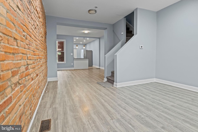 524 N Loudon Ave, Baltimore, MD 21229 - interior space featuring stairs, visible vents, wood finished floors, and brick wall