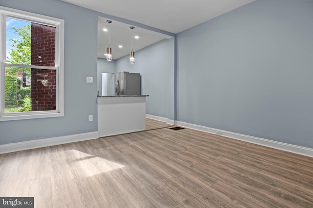 524 N Loudon Ave, Baltimore, MD 21229 - unfurnished living room with baseboards, visible vents, and wood finished floors