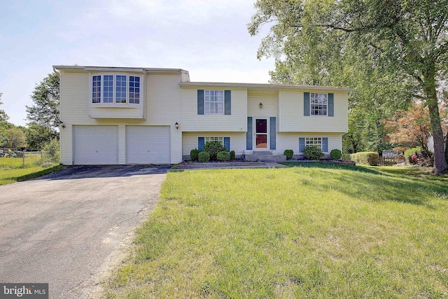 raised ranch with driveway and an attached garage