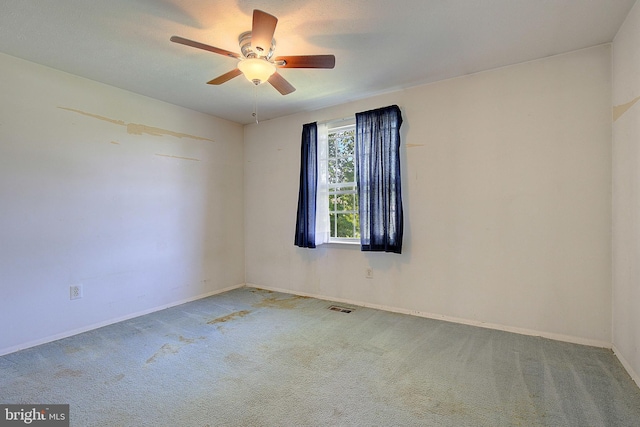 unfurnished room featuring carpet, ceiling fan, and baseboards