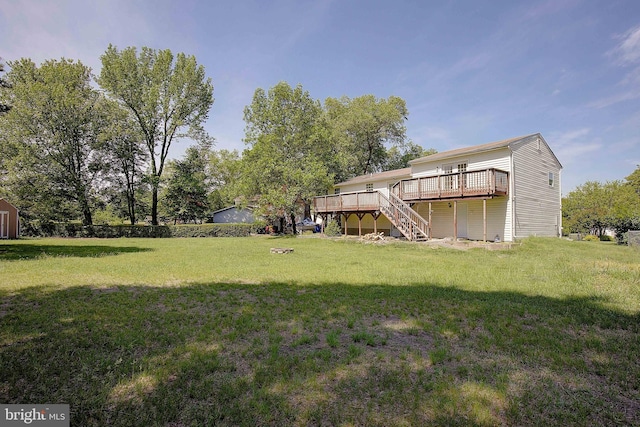 view of grassy yard with stairs and a deck