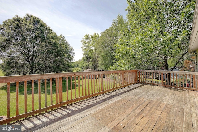 wooden terrace featuring a yard