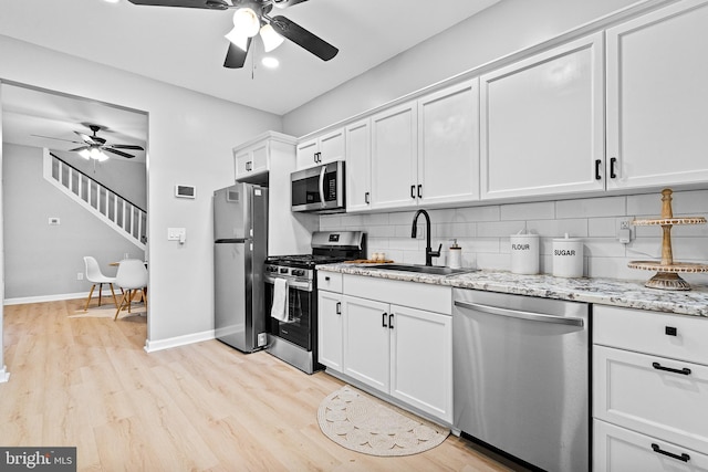 3602 5th St, Baltimore, MD 21225 - kitchen with appliances with stainless steel finishes, a sink, a ceiling fan, tasteful backsplash, and recessed lighting
