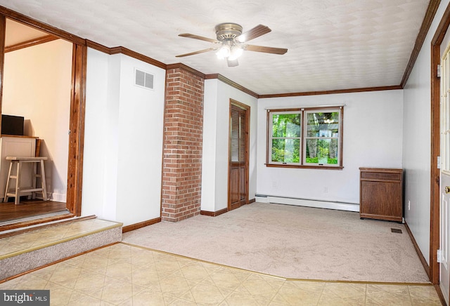 empty room with carpet floors, baseboard heating, a ceiling fan, baseboards, and crown molding